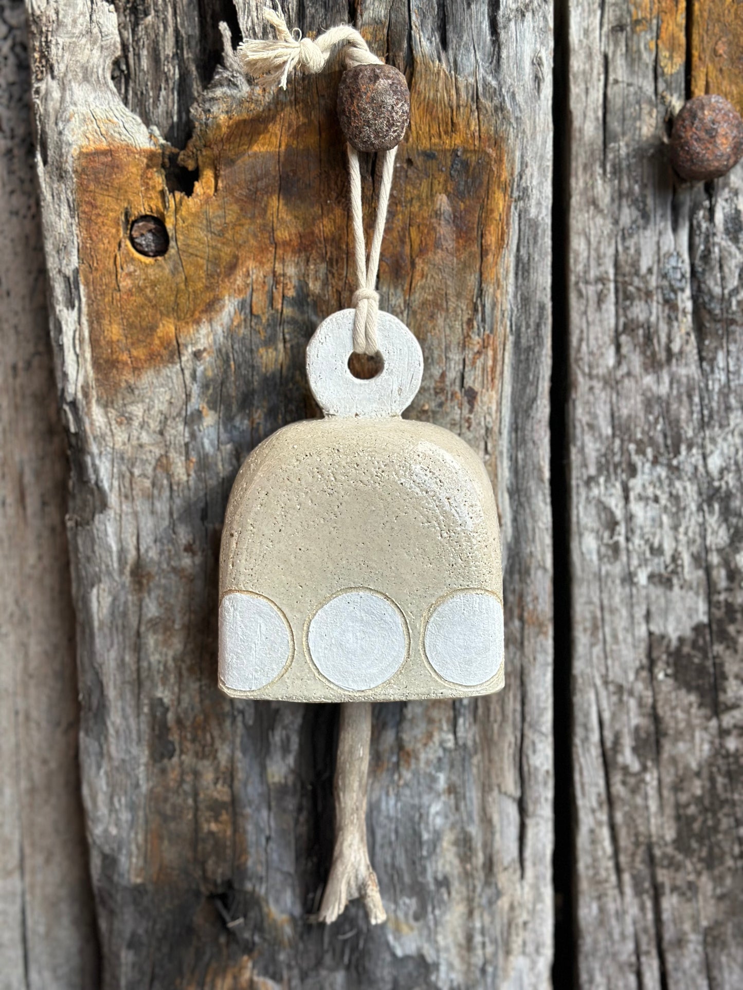 High-fired stoneware bell with subtle glaze, modernist dot design, and natural wood striker by Heidi Dickinson – Denmark, WA