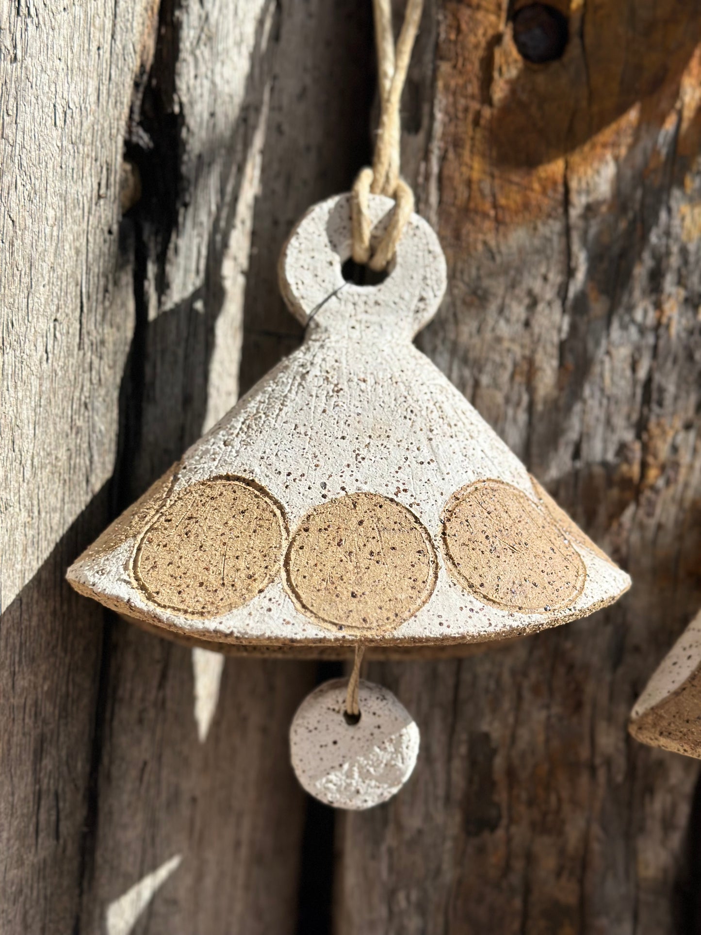 Danish-inspired ceramic taco bell with raw speckled stoneware finish and minimalist circular detailing