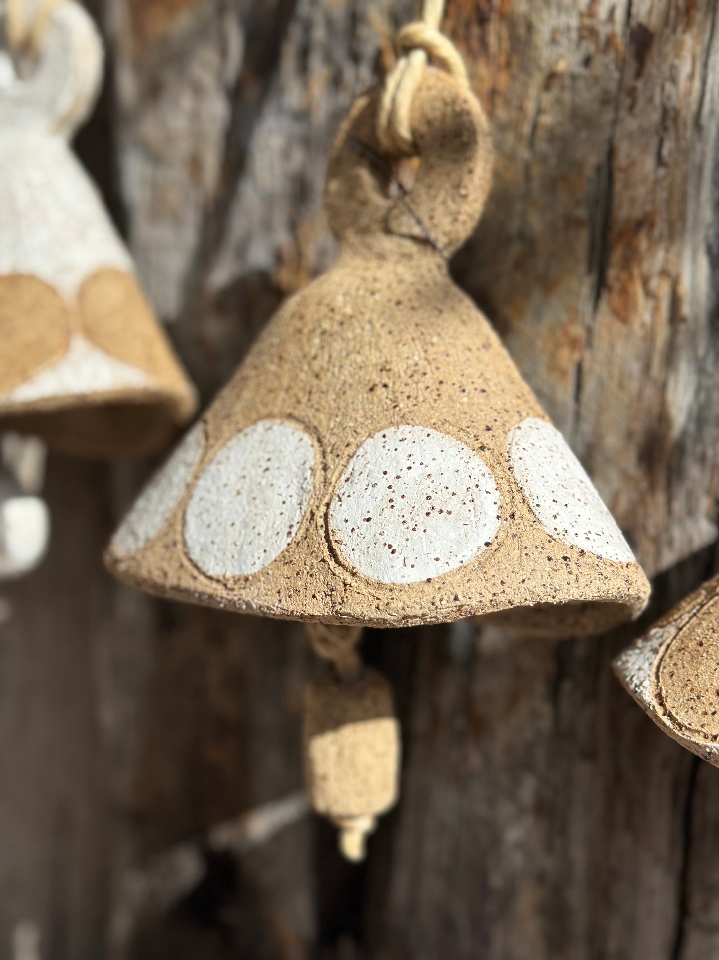 Danish-inspired ceramic taco bell with raw speckled stoneware finish and minimalist circular detailing