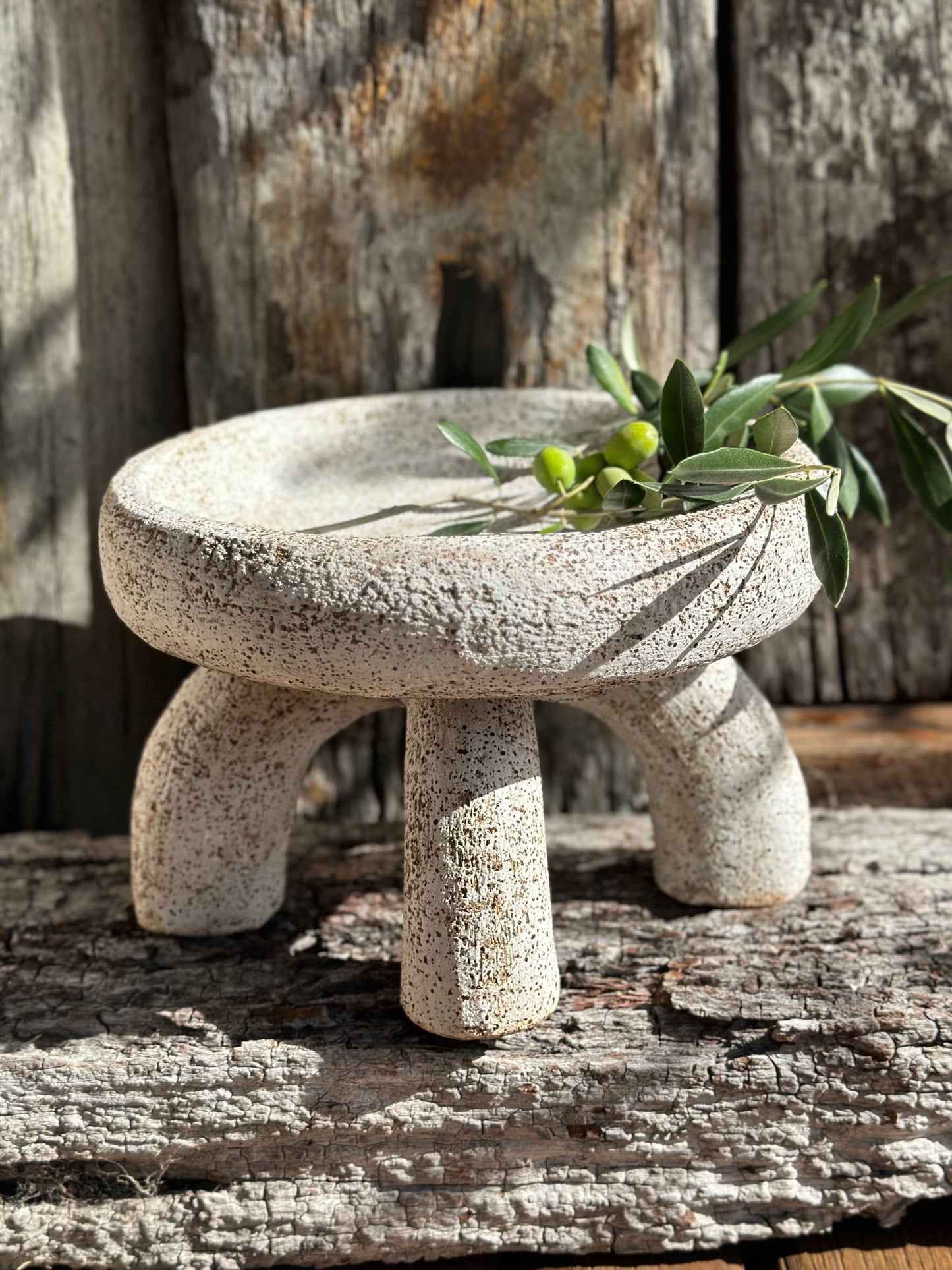 Two-piece hand-built ceramic vessel with whitewashed compressed bowl resting on arched stoneware supports