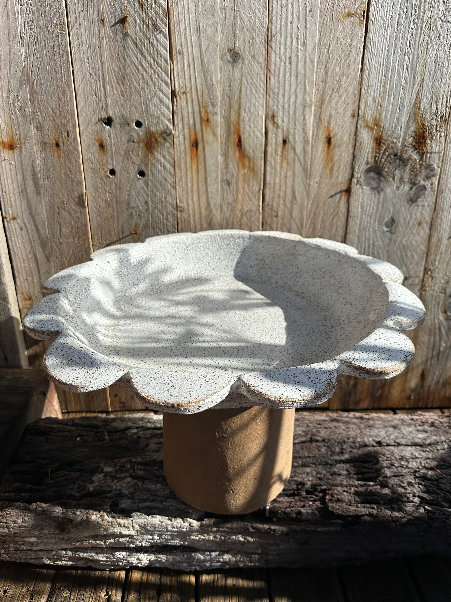 Overhead view of scalloped-edge ceramic basin resembling a blooming sun or flower form.