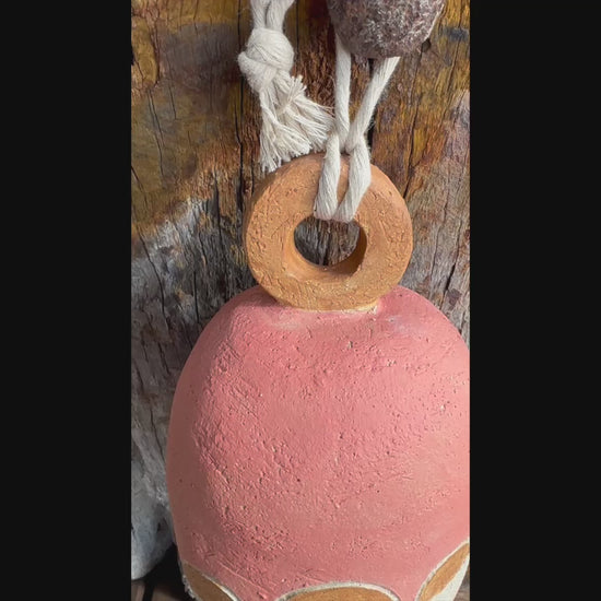  Short video Handcrafted stoneware bell made from textured white raku clay with white circular motif, Danish-inspired design by Heidi Dickinson
