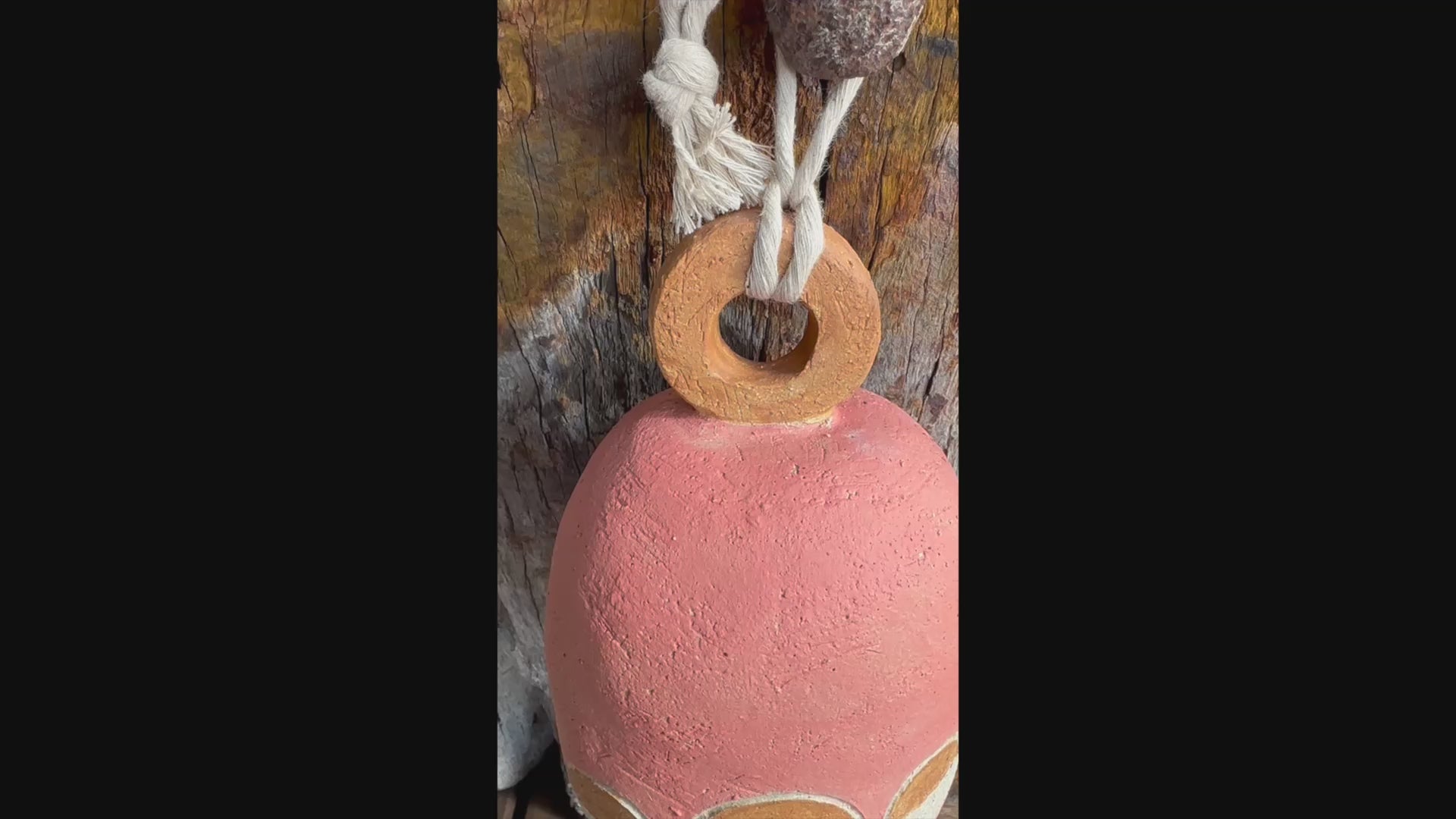  Short video Handcrafted stoneware bell made from textured white raku clay with white circular motif, Danish-inspired design by Heidi Dickinson