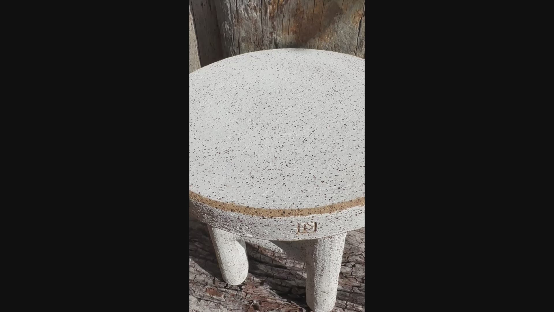 Short video Handmade ceramic stool with four legs, white underglaze, and exposed clay rim Handmade ceramic milking stool with white underglaze and exposed raw clay rim, shown in full view